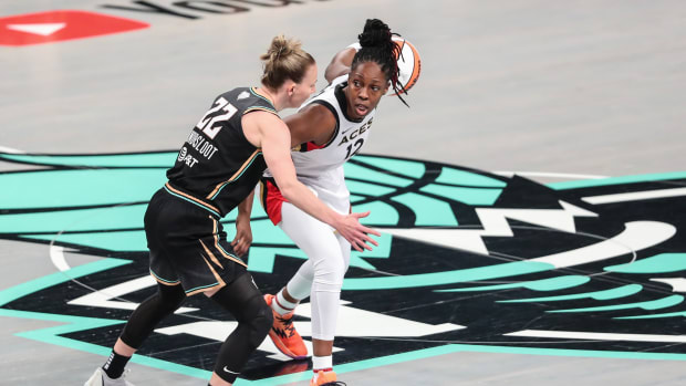 Las Vegas Aces guard Chelsea Gray dribbles past New York Liberty guard Courtney Vandersloot.